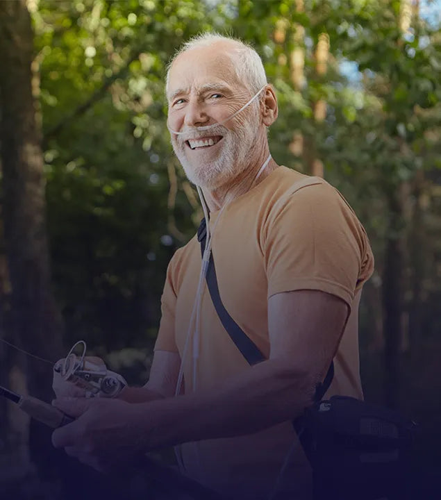 Man smiling while fishing and using a Kingon P2 portable oxygen concentrator.