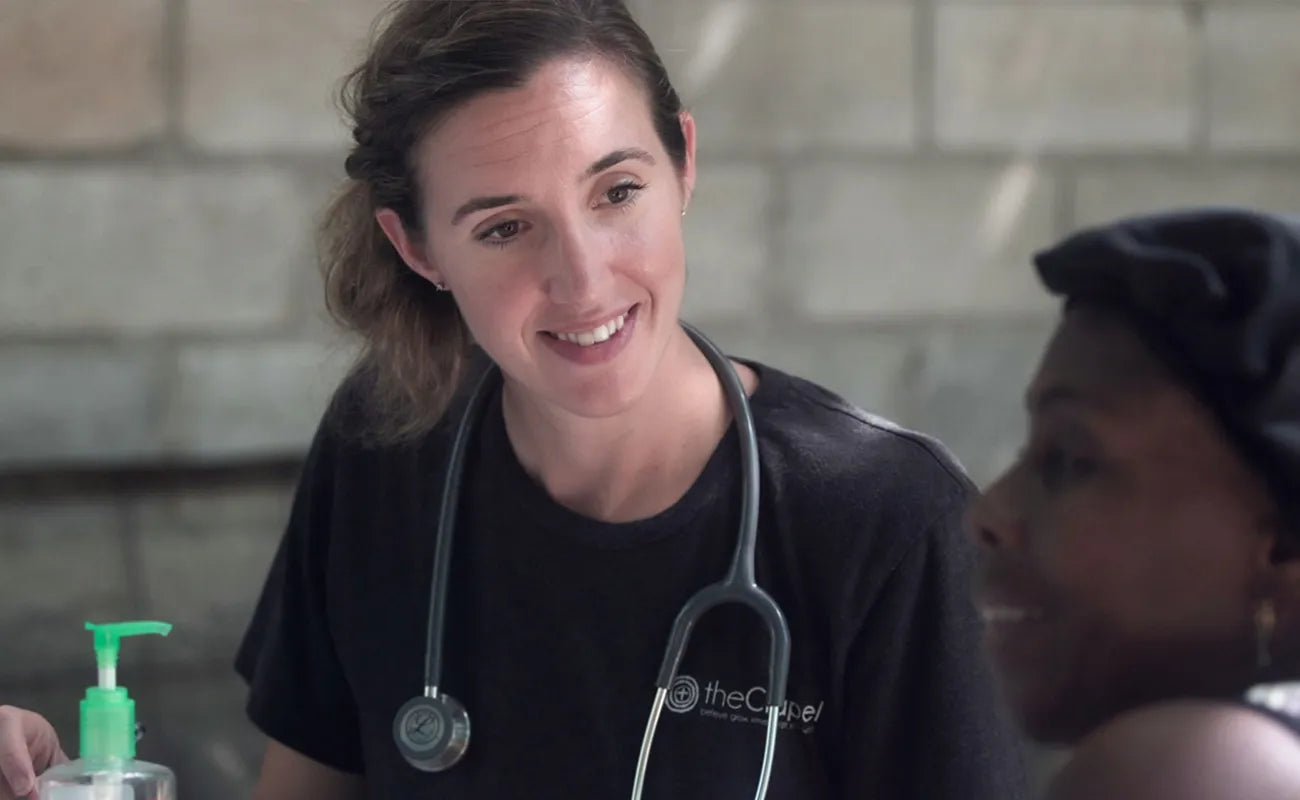 Practitioner or nurse looking at patient smiling. Shop now at Kingon.