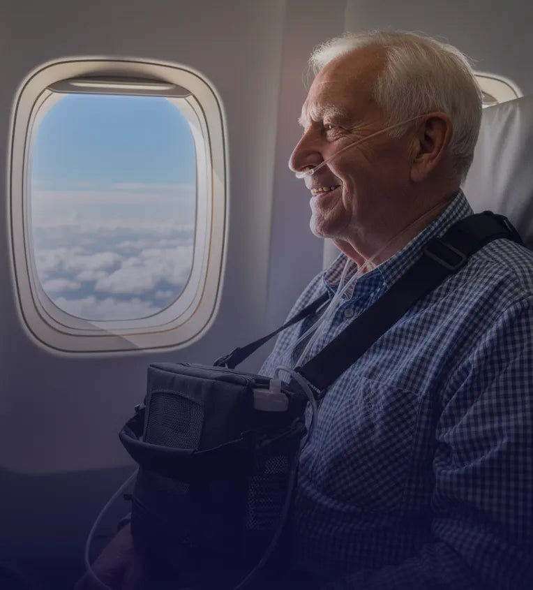 Old man smiling by a window plane in the sky using a Kingon P2 portable oxygen concentrator. Shop now at Kingon Australia.
